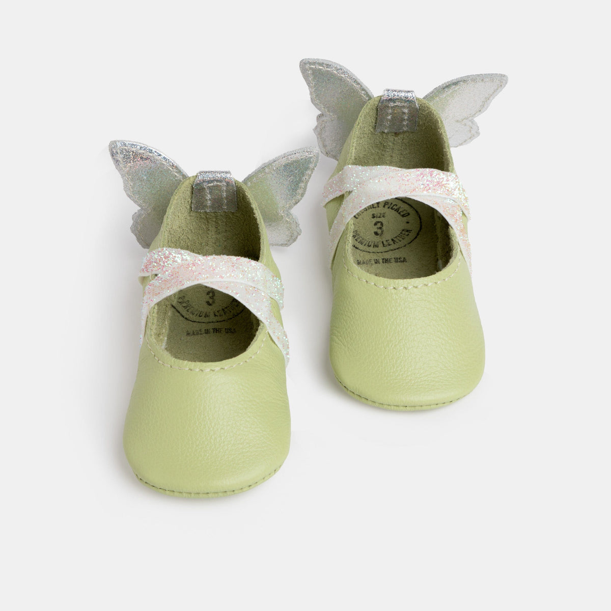 Baby ballet slippers in mint green with glitter butterfly wings and bow strap