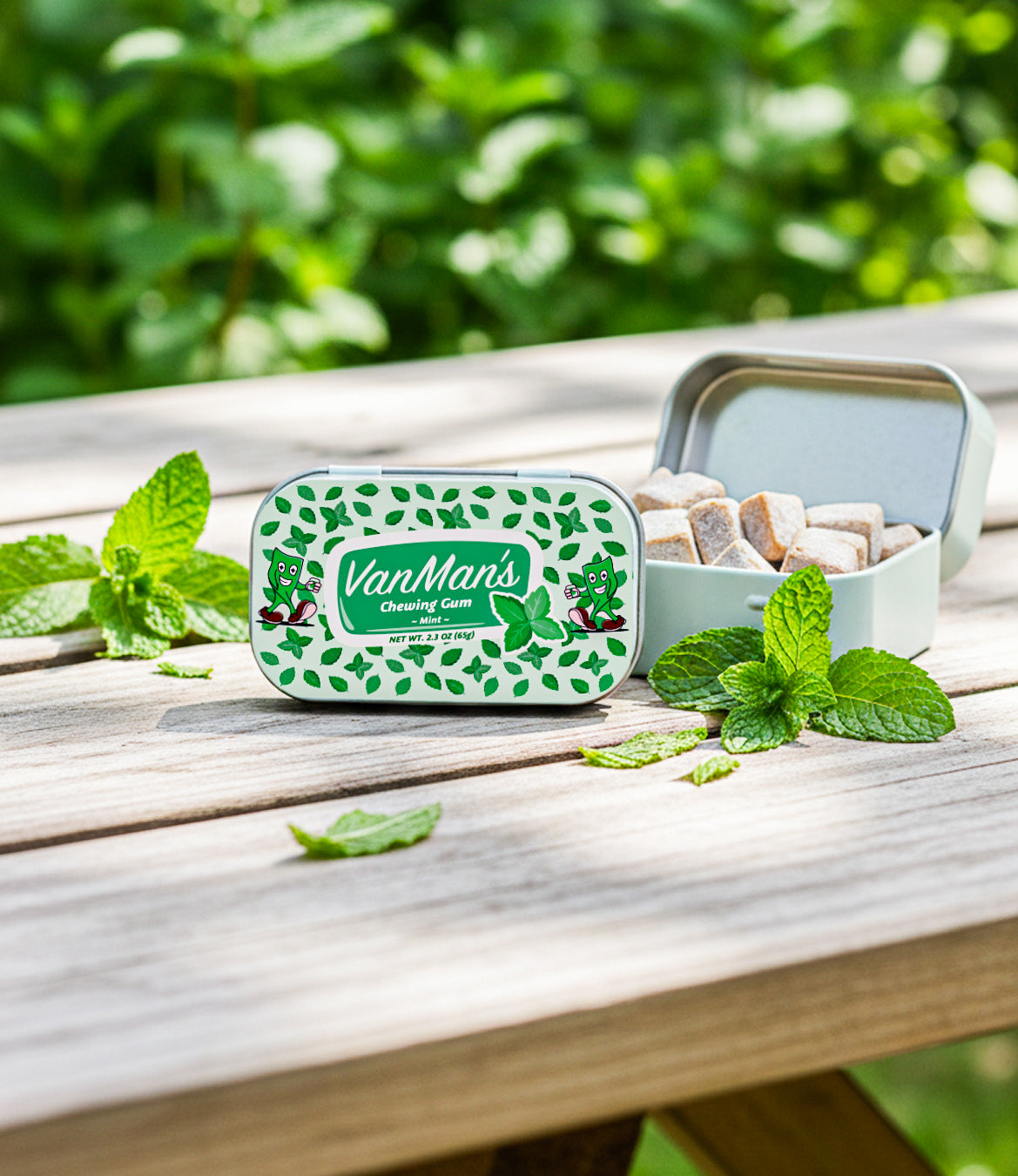 Mint remineralizing chewing gum tin on wooden table with mint leaves