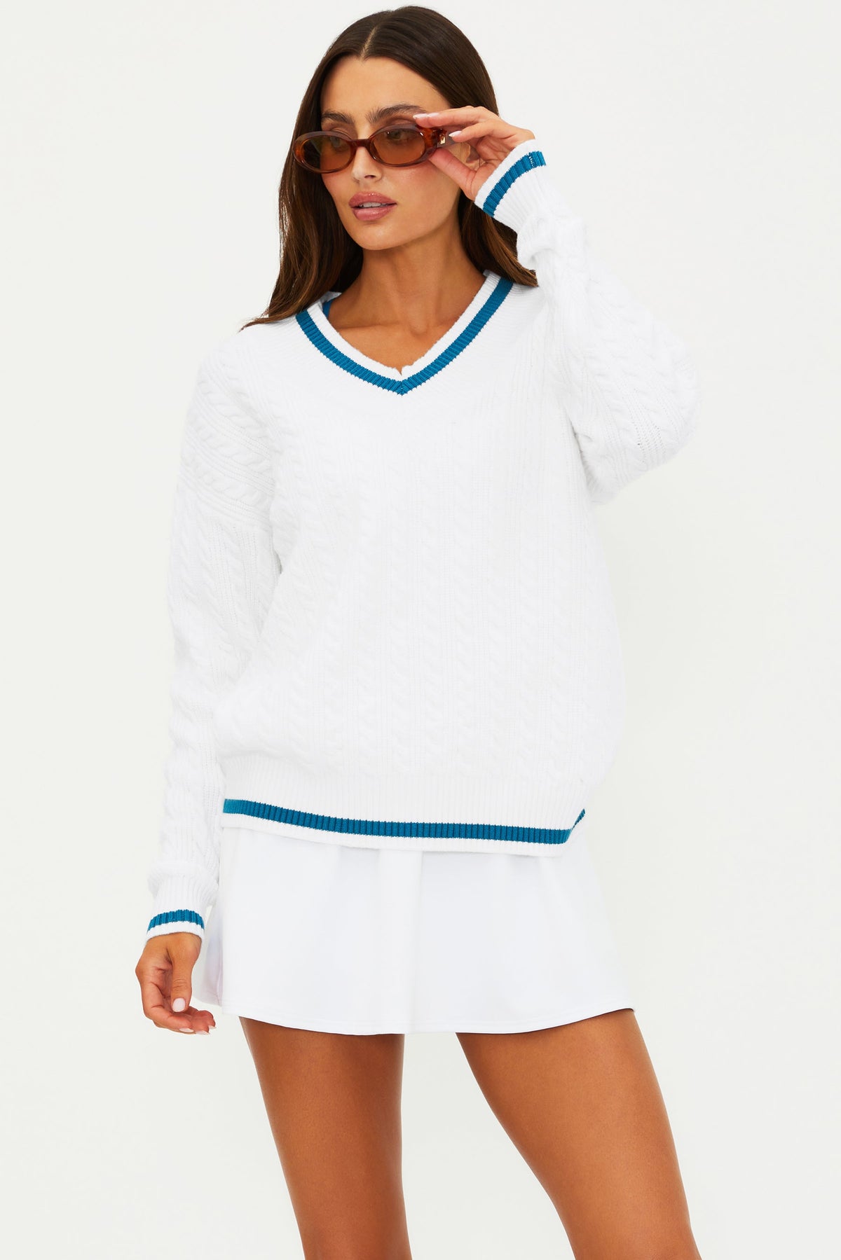 Women's white V-neck sweater with blue ribbed trim at collar, cuffs, and hem