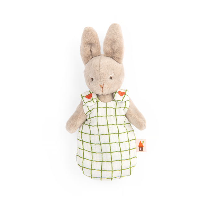 Plush rabbit doll in a white dress with a green grid and red flower details