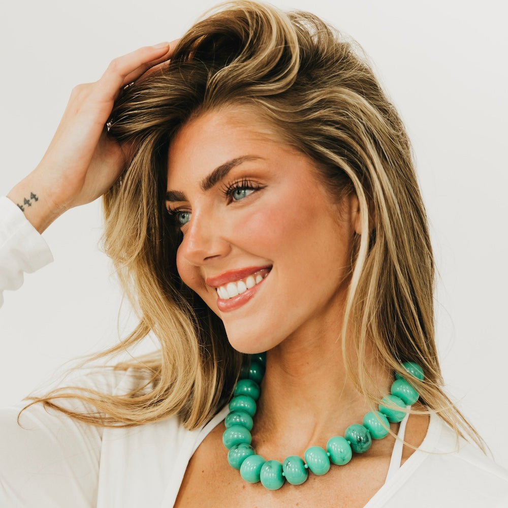 Turquoise beaded necklace with chunky round beads and layered strand design