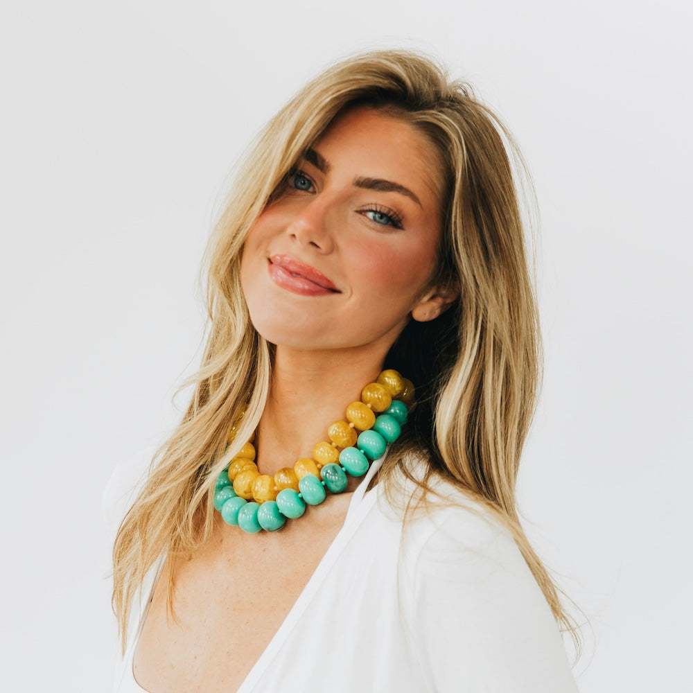 Beaded necklace with yellow, turquoise, and amber-toned chunky round beads
