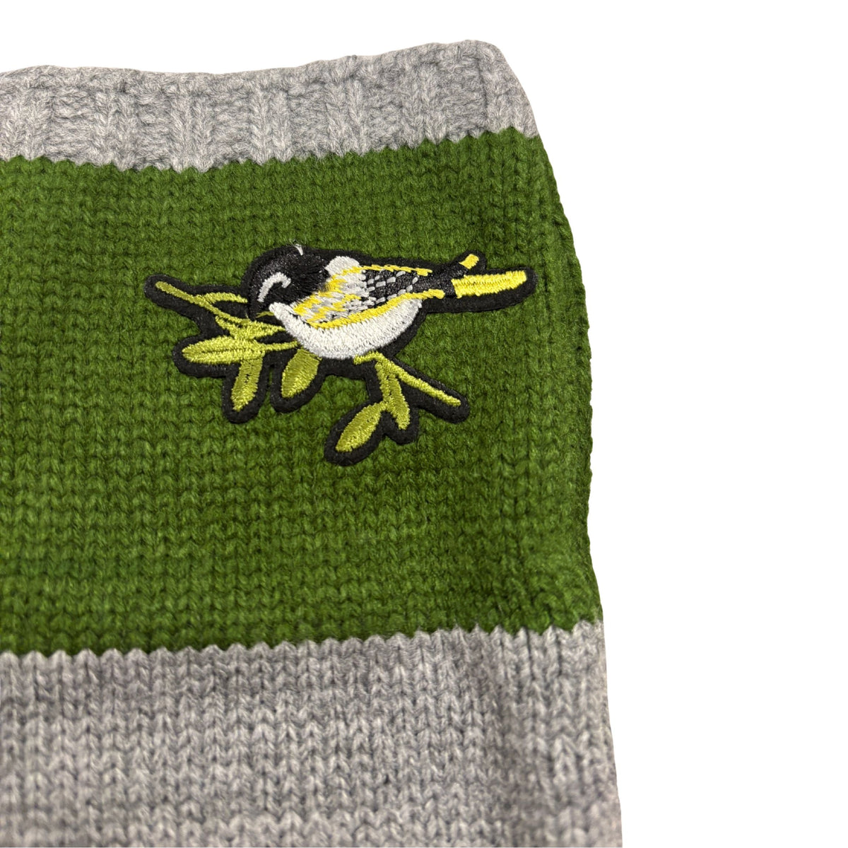 Green knitted arm warmer with bird applique and gray stripes; ribbed cuff