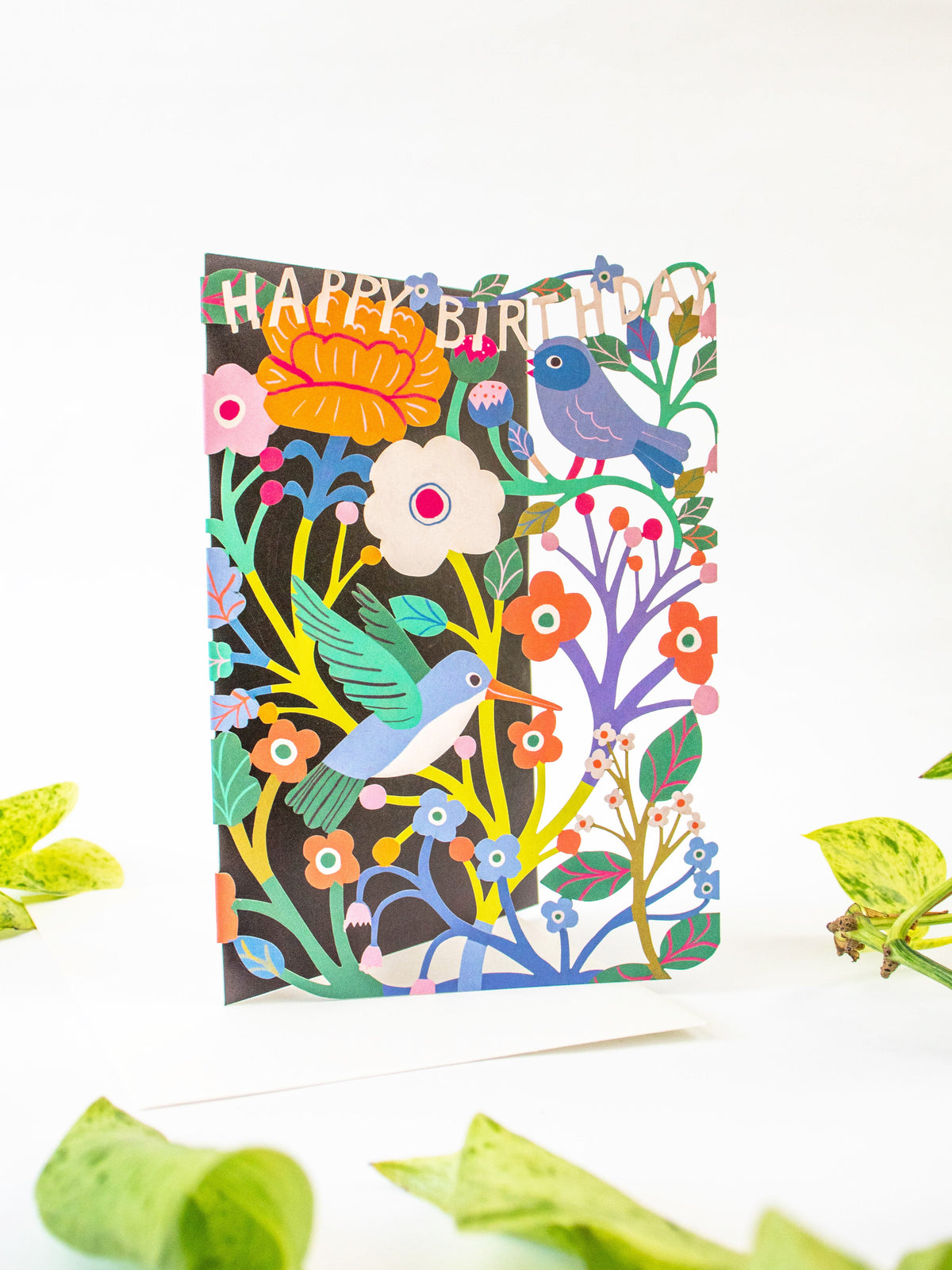 Laser-cut birthday card with colorful birds, flowers, and “Happy Birthday” banner