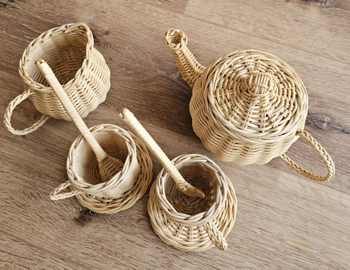 Natural wicker tea party set with a teapot, cups, and spoons