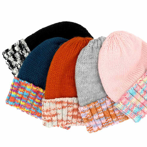 Assorted knit fleece beanies in black, navy, rust, gray, and pink with bands