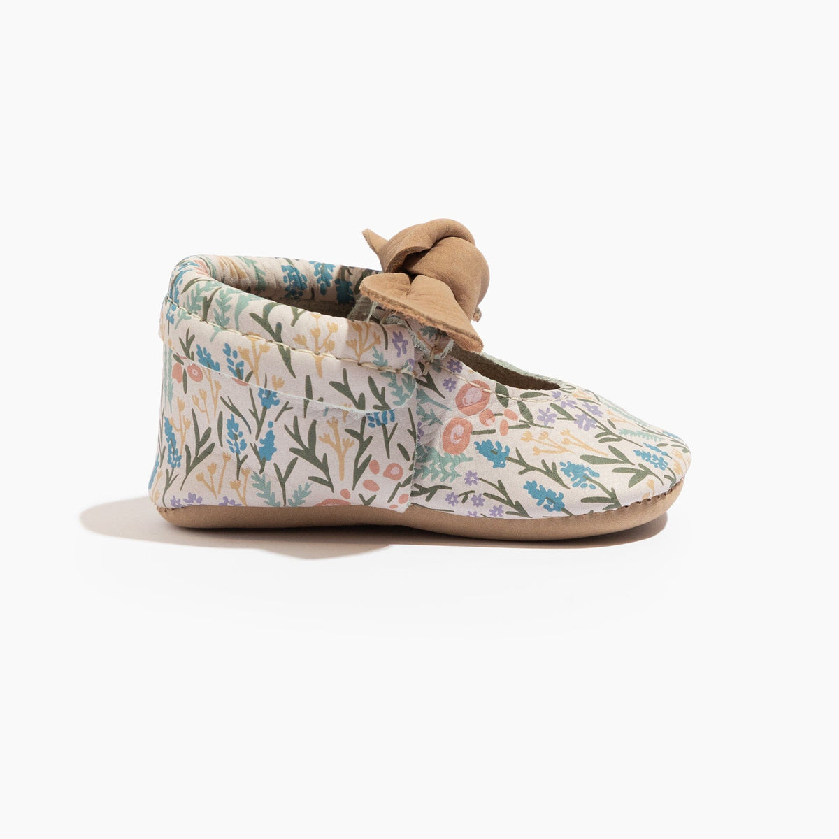 Baby floral slip-on shoes, side view with tan knotted bow on the cuff