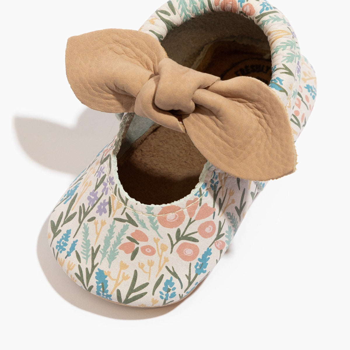 Baby floral slip-on shoes with knotted bow, tan collar, and soft interior