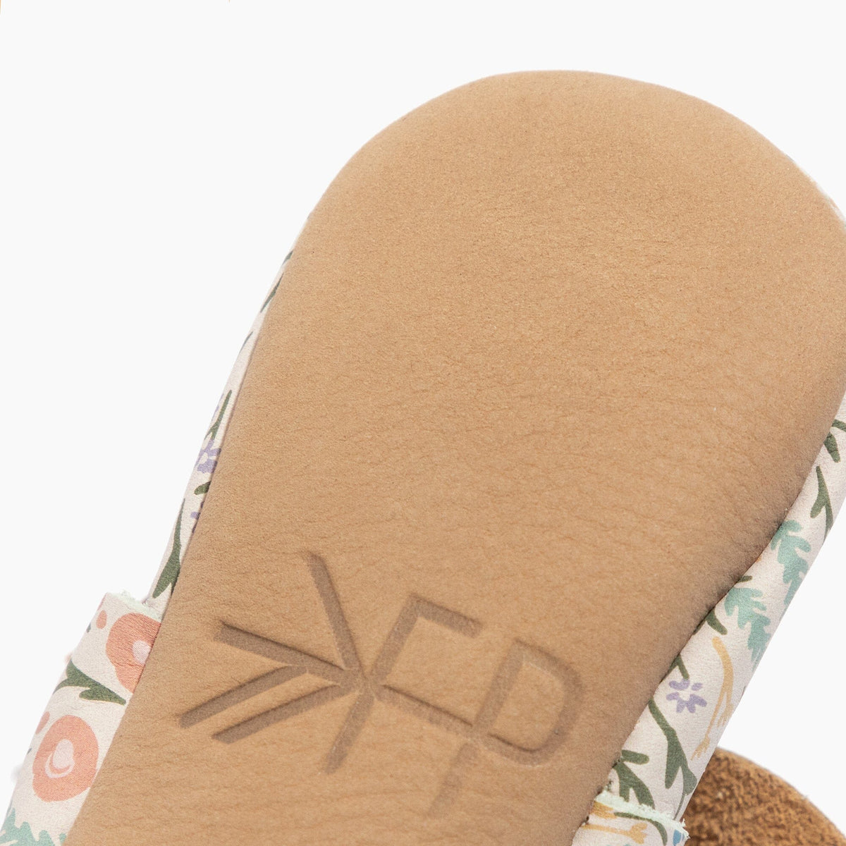 Baby shoe outsole closeup with embossed ZFP on tan sole