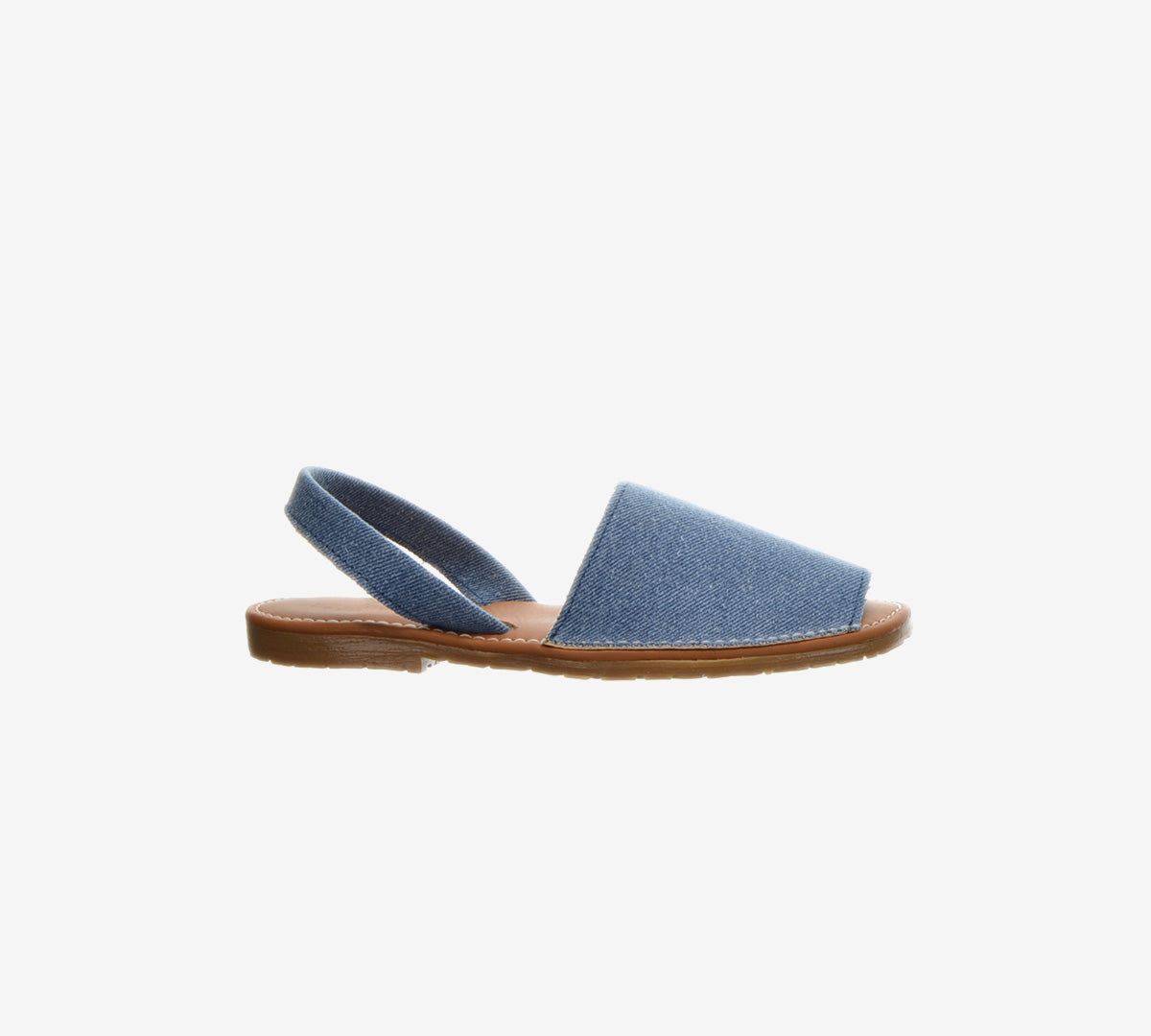 Side view of a blue denim Menorcan sandal with an open heel and brown flat sole.
