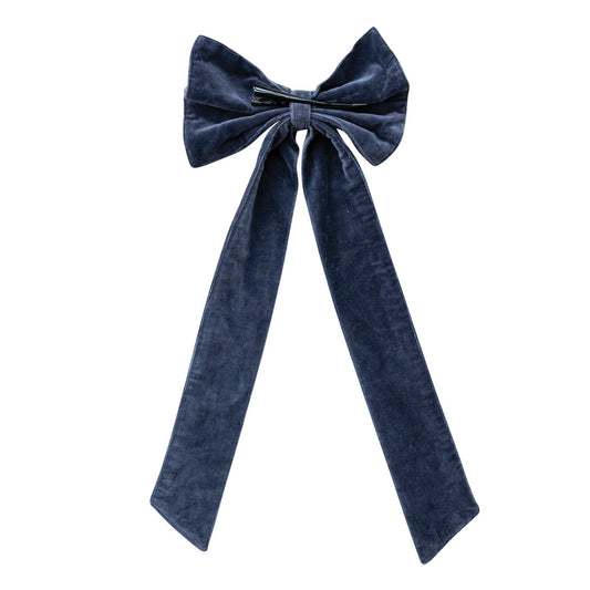 Navy velvet bow with gathered center and long ribbon tails