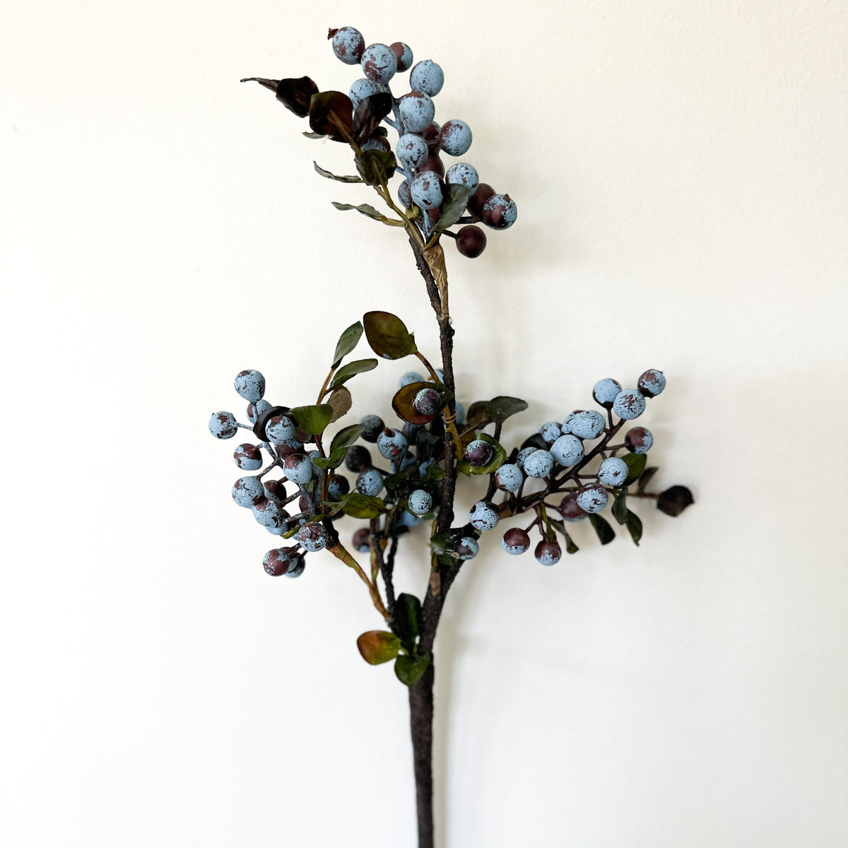 Artificial berry spray stem with blue berry clusters and green eucalyptus leaves