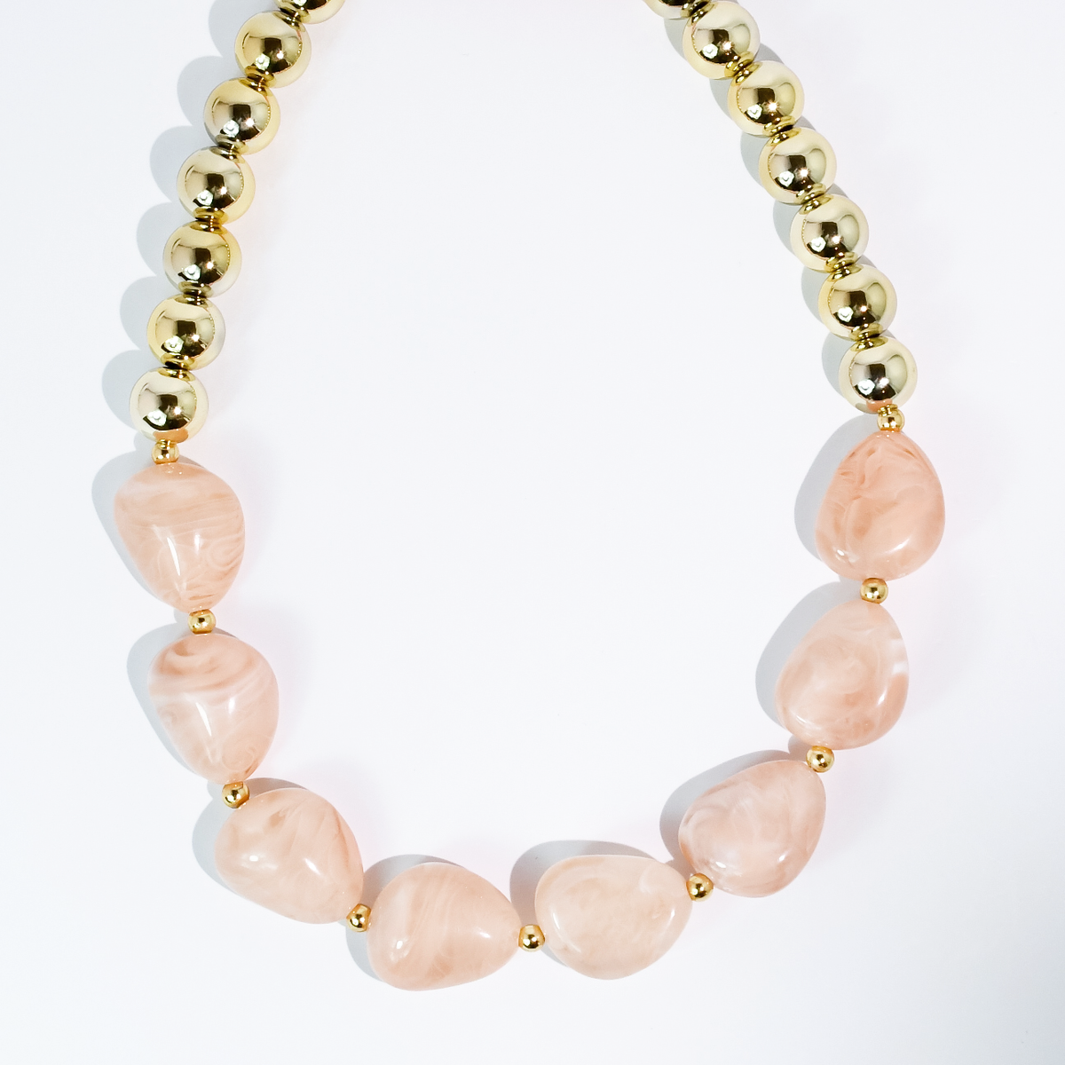 Gold beaded necklace with blush pink oval beads and round spacers