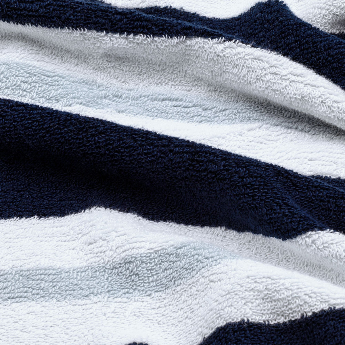 Terry fabric close-up of navy and white striped cotton beach towel