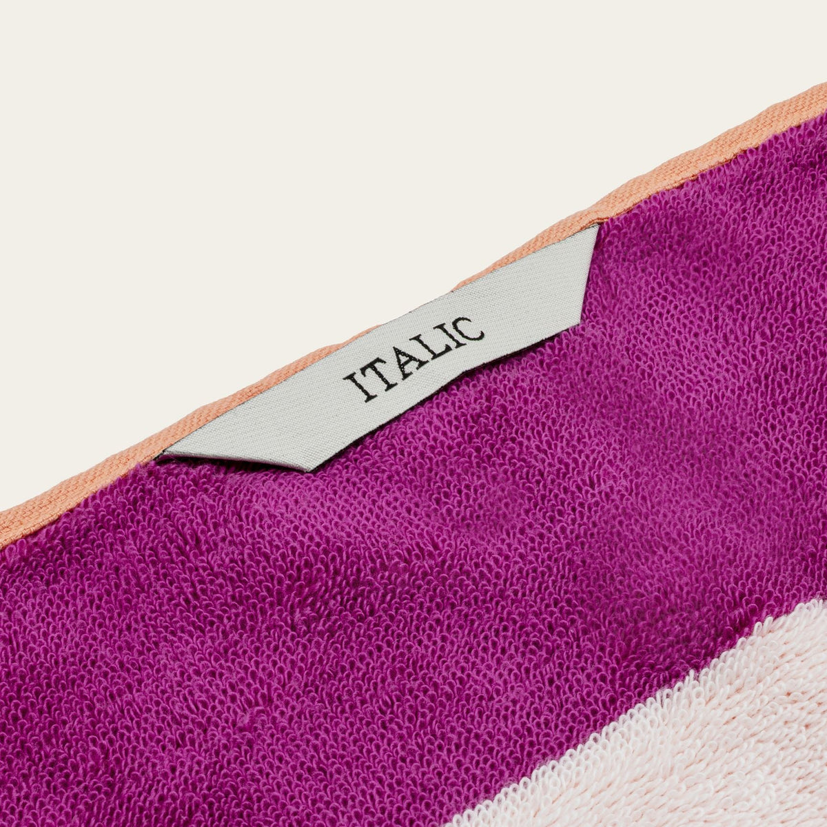 Purple cotton beach towel corner with stitched ITALIC label