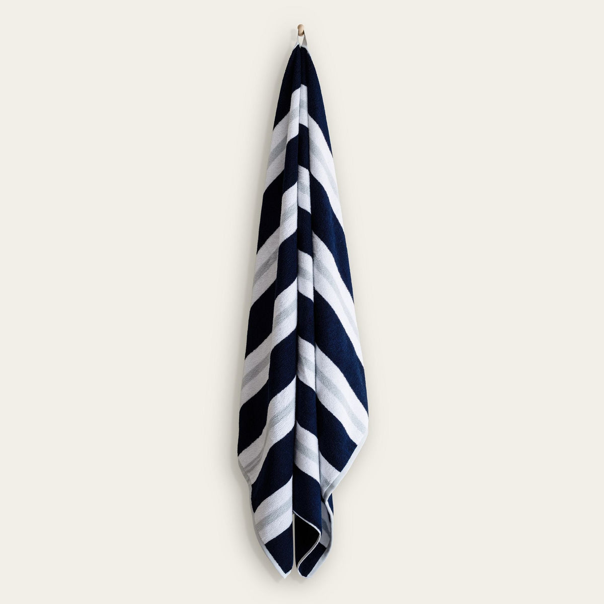 Navy-and-white striped cotton beach towel hanging