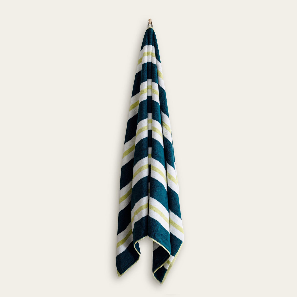 Navy and white striped cotton beach towel with light green accents hanging