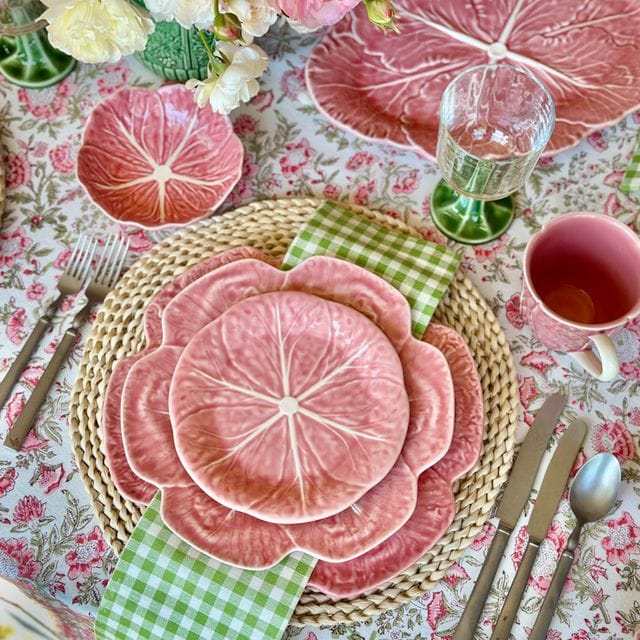 Pink cabbage-shaped serving bowl with leaf veins and scalloped edge.