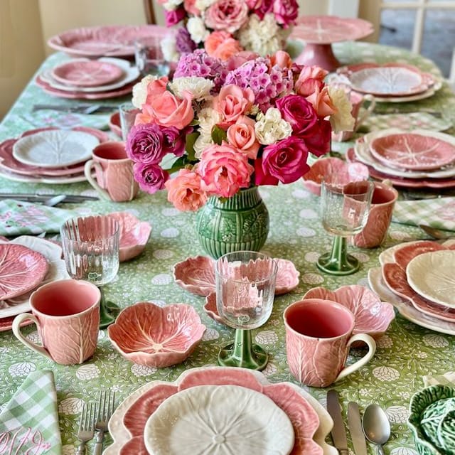 Pink cabbage-shaped bowls and plates with a mix of green and pink pieces.