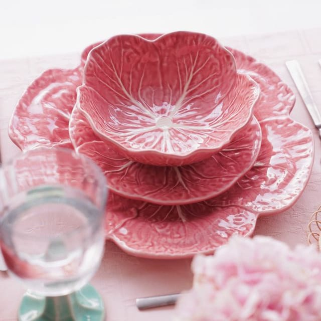 Stacked pink ceramic cabbage-leaf bowls with white vein details, top bowl shown