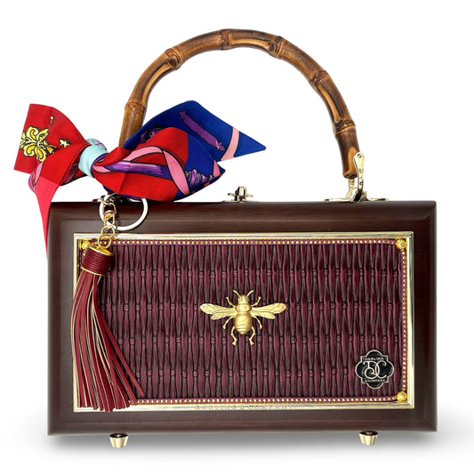 Bordeaux garden bag with bamboo handle, burgundy fringe front, and brass bee clasp