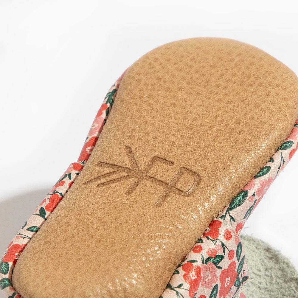 Tan outsole and edge of floral upper from underside close-up