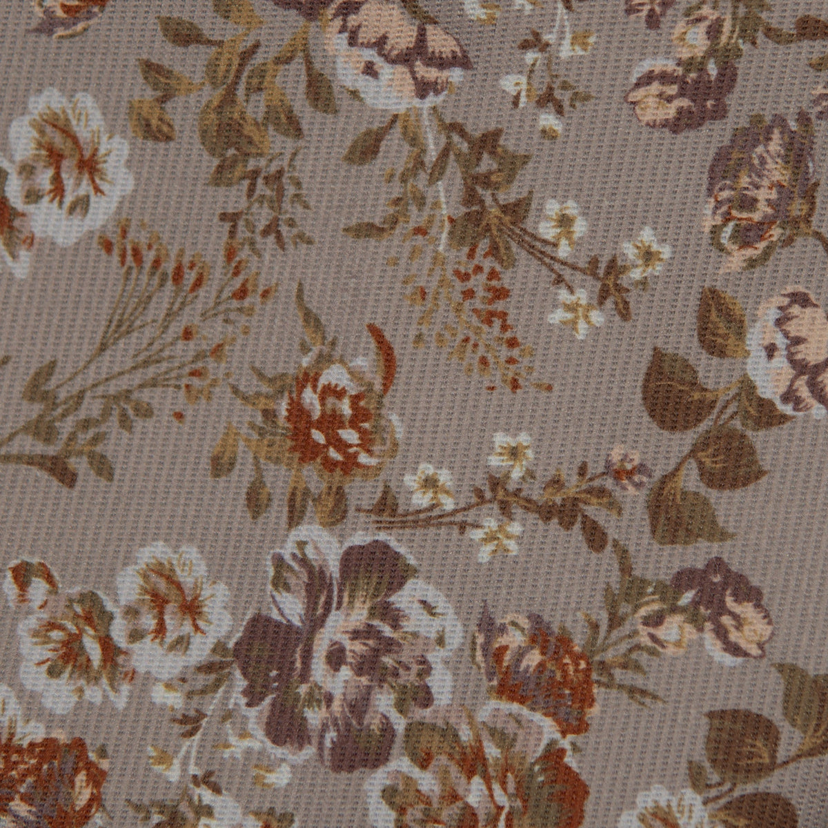 Tan fabric with dense orange, brown, and cream floral pattern for hair bow