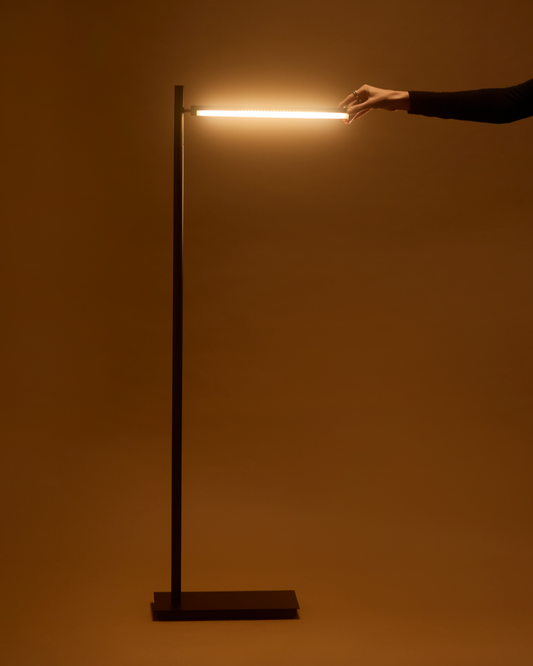 Black floor lamp with tall slim pole, horizontal LED bar, and rectangular base