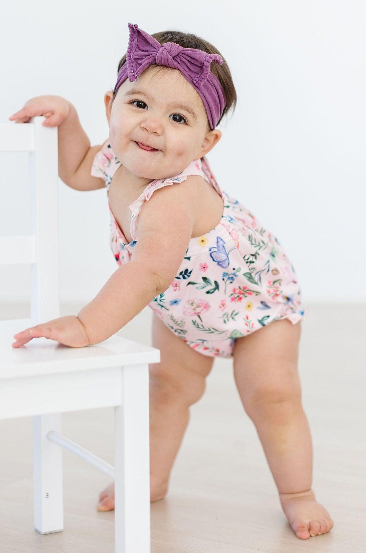 Floral ruffled romper with cross-back straps and short diaper cover