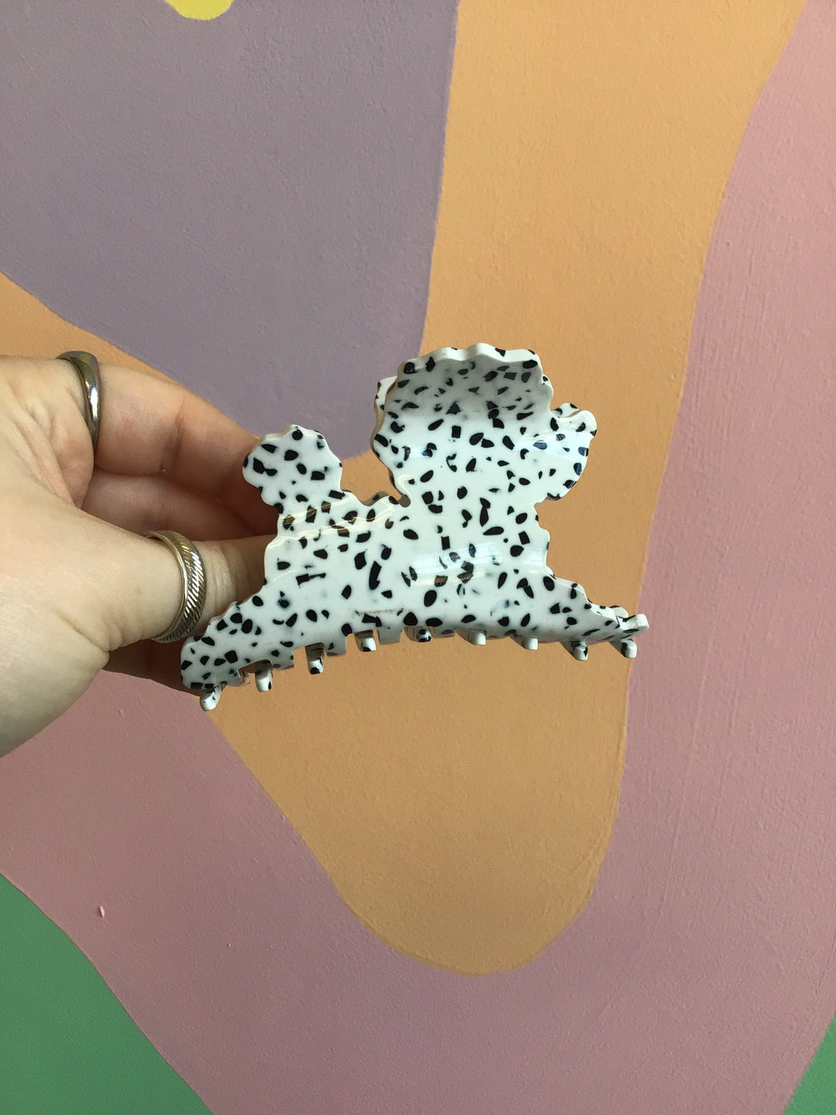 Dalmatian-style animal hair claw clip, black spots on white base with rounded shape