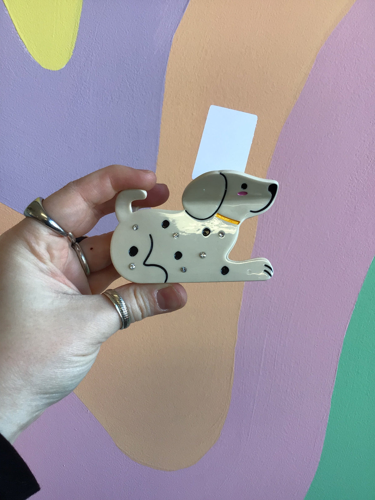 Cream animal hair claw with small black spots and catlike face detail