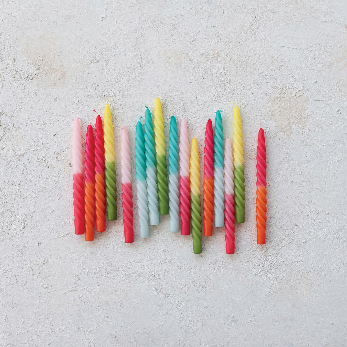 Twisted taper candles with bright ombre twists, assorted colors on wall