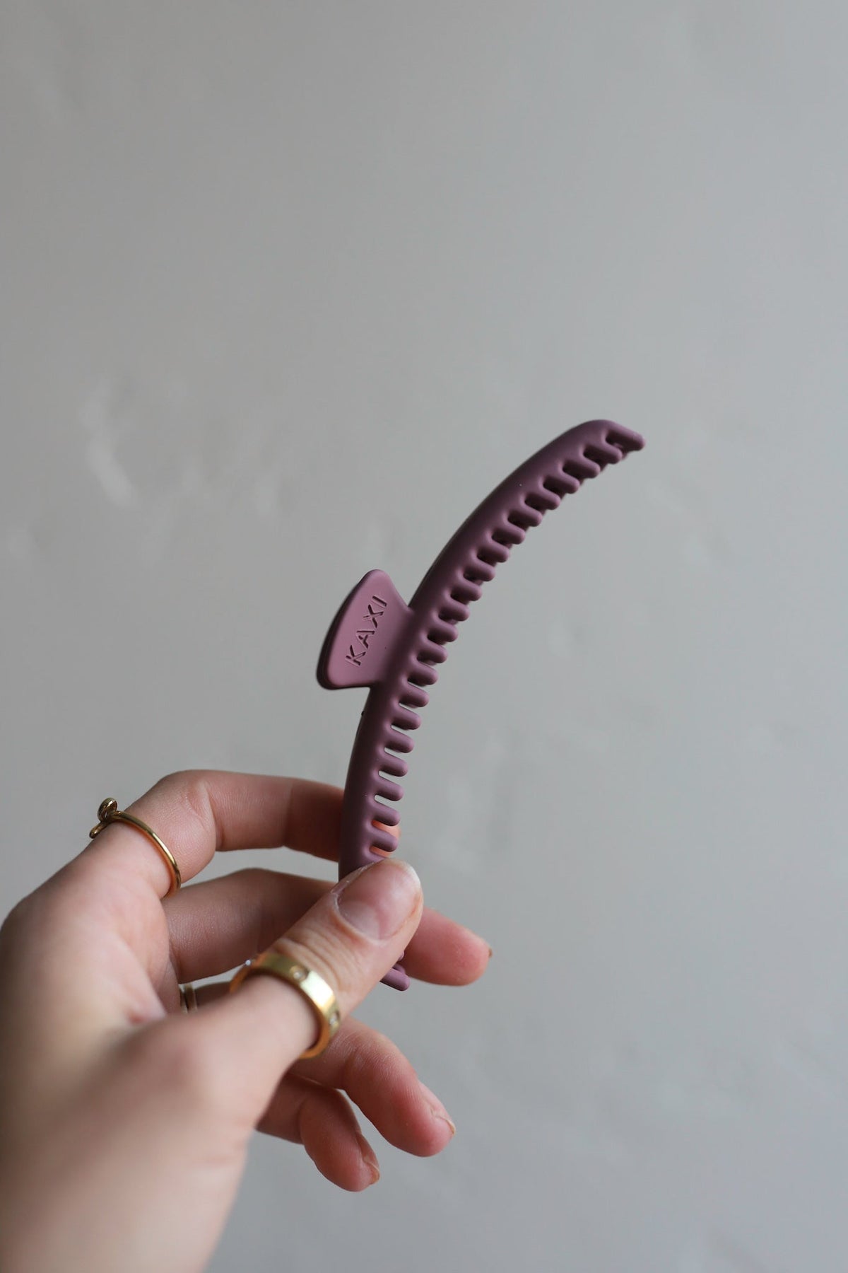 Purple hair claw clip with serrated grip teeth