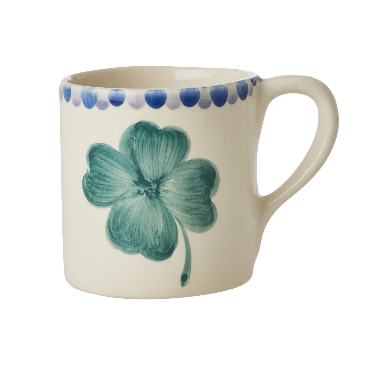 Ceramic mug with teal clover design, blue dot rim, and white handle