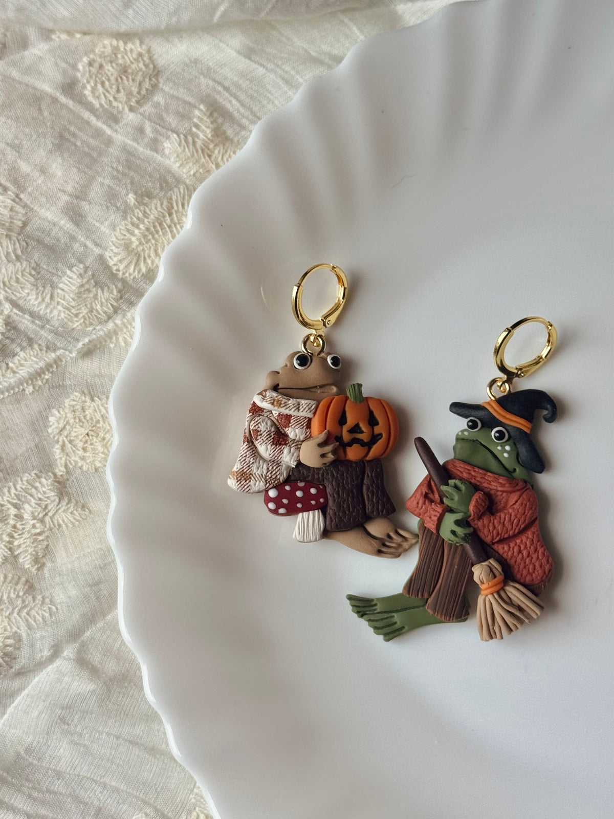 Frog and toad Halloween dangle earrings with pumpkin, broom, and leaf charms