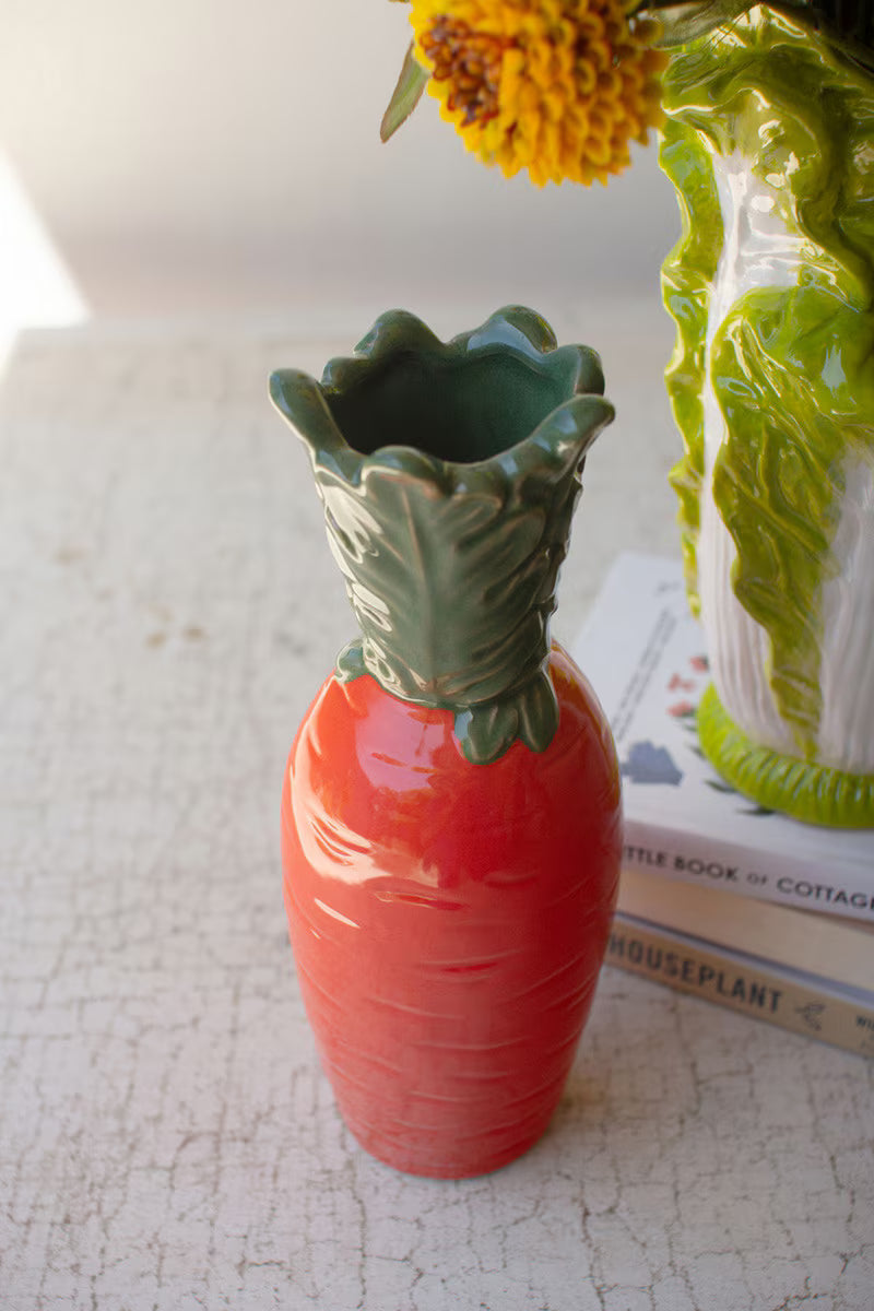 Orange ceramic carrot vase, glossy with scalloped green top and ridges