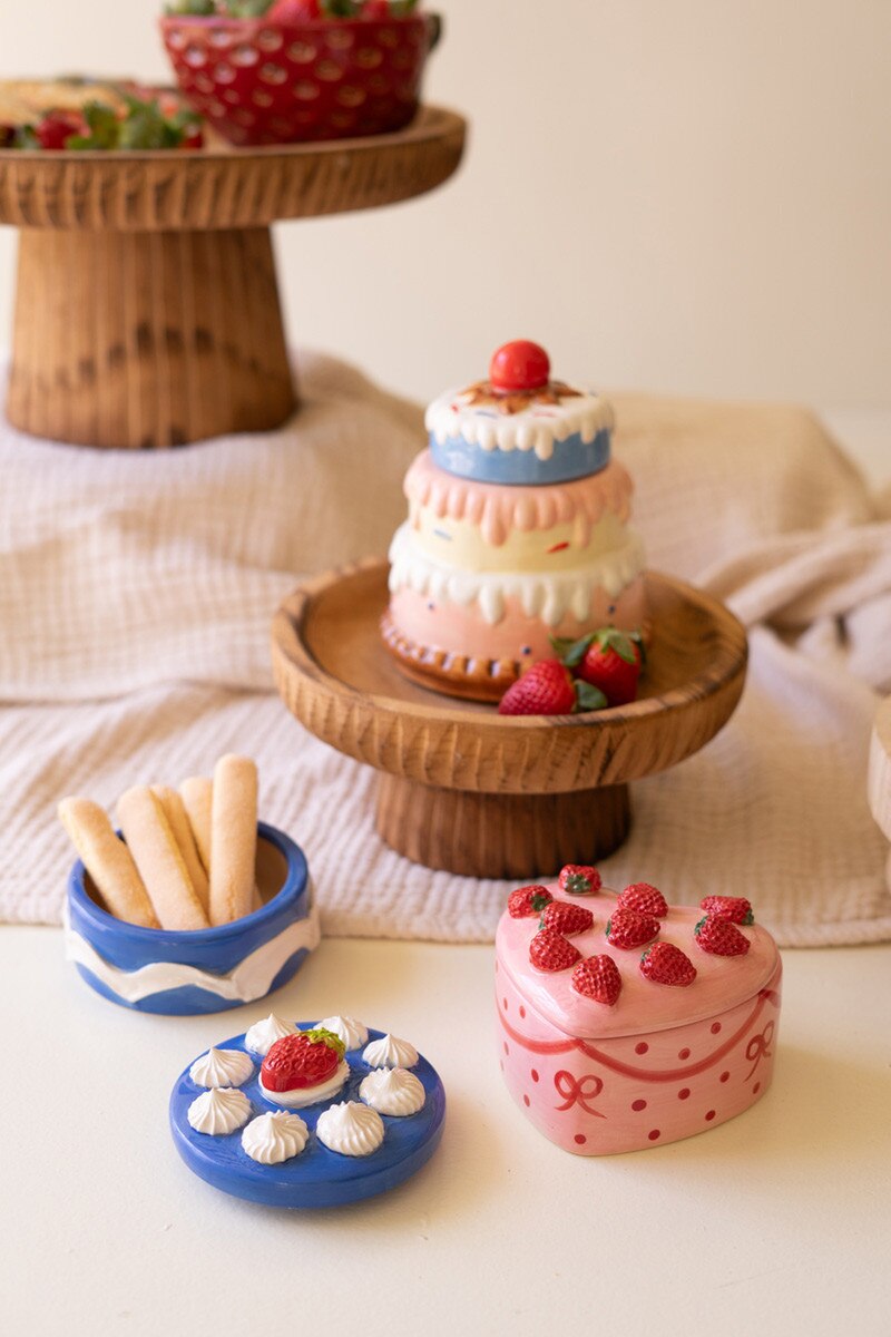 Ceramic cake-style trinket boxes in pastel colors: tiered cake, blue platter, pink strawberry