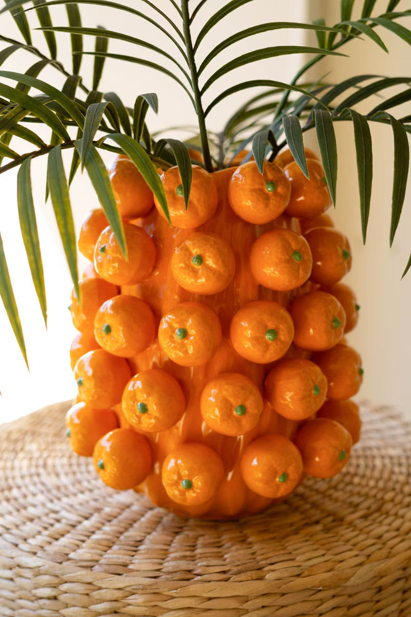 Orange ceramic cluster vase with rounded fruit-like spheres and green dot details