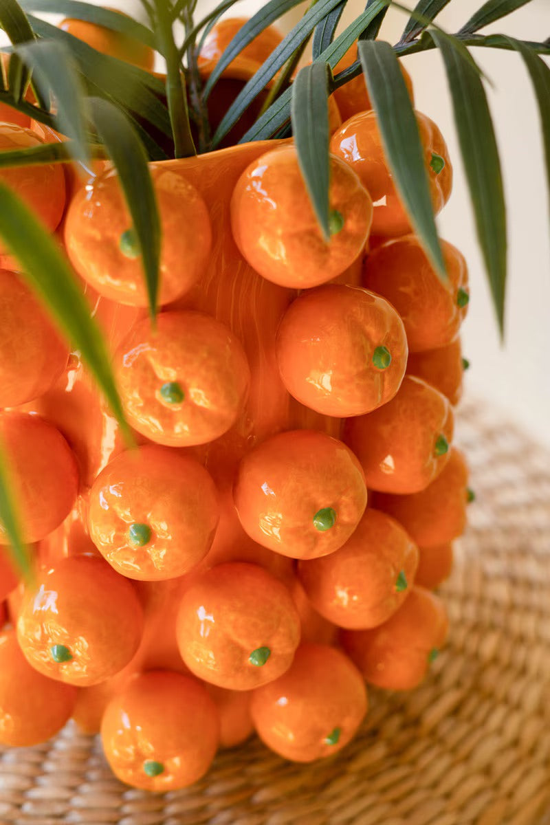 Orange ceramic cluster vase close-up of glossy spheres with green dot insets