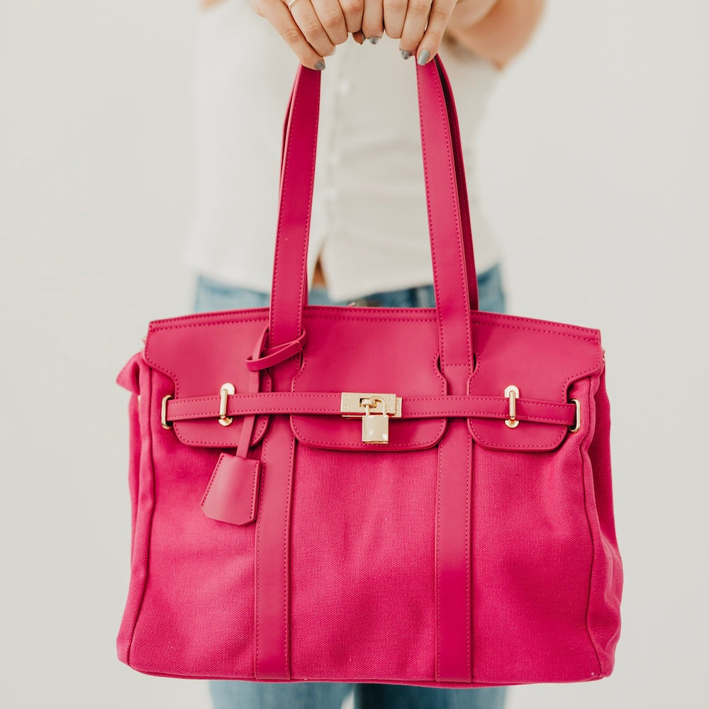 Fuchsia canvas and vegan leather tote with front buckle strap and handles