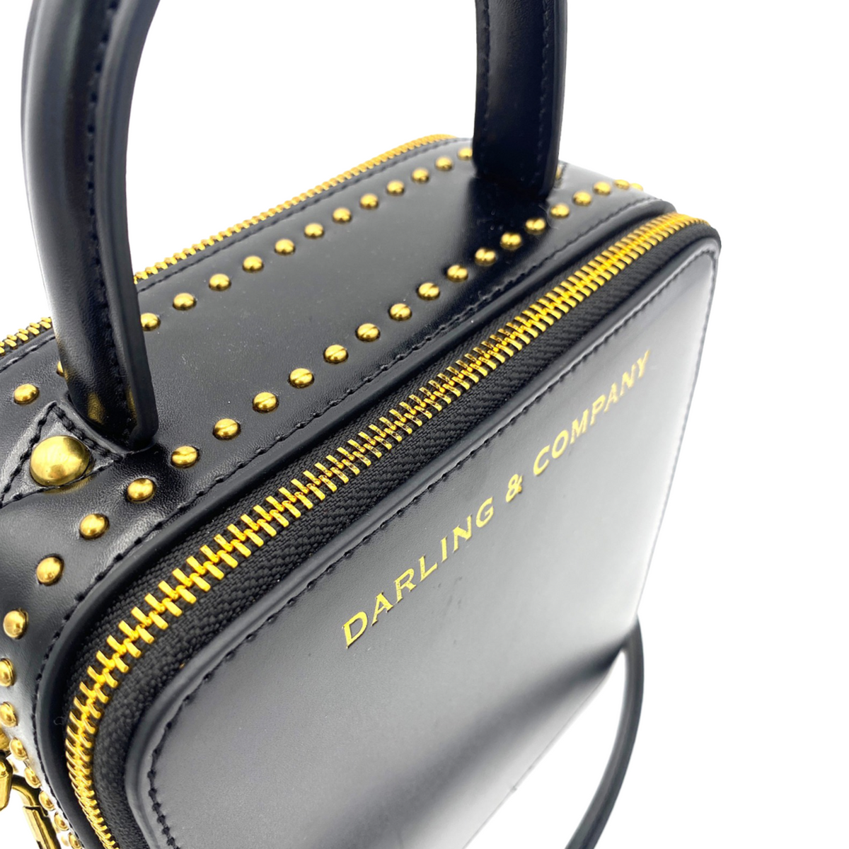 Black leather bag strap with gold studs and stitched trim