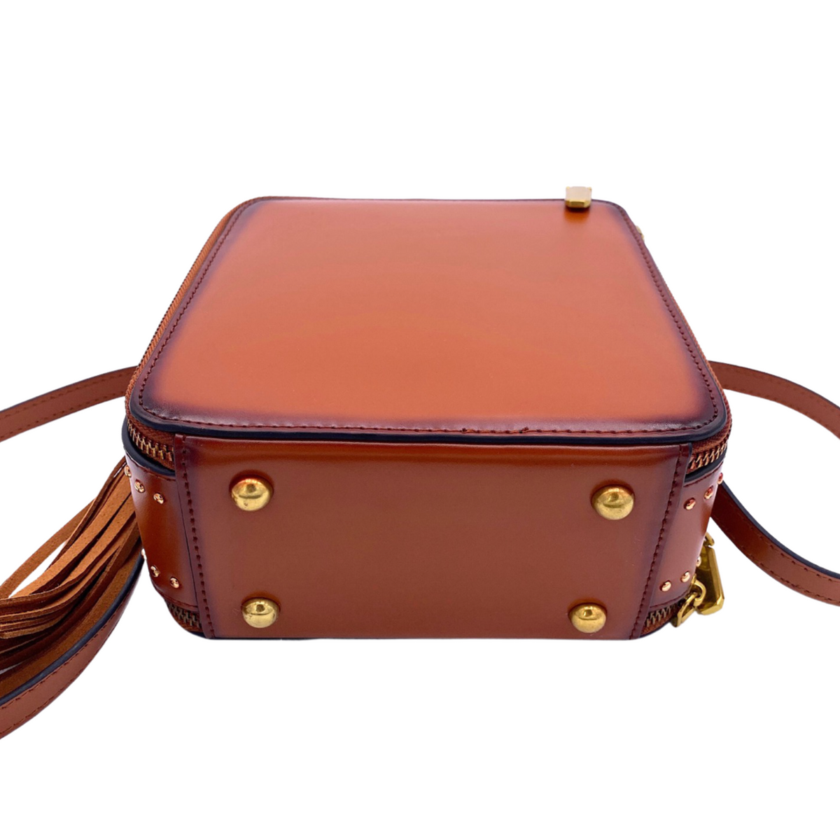 Saddle-colored mini handbag with top handle, gold studs, and tassel