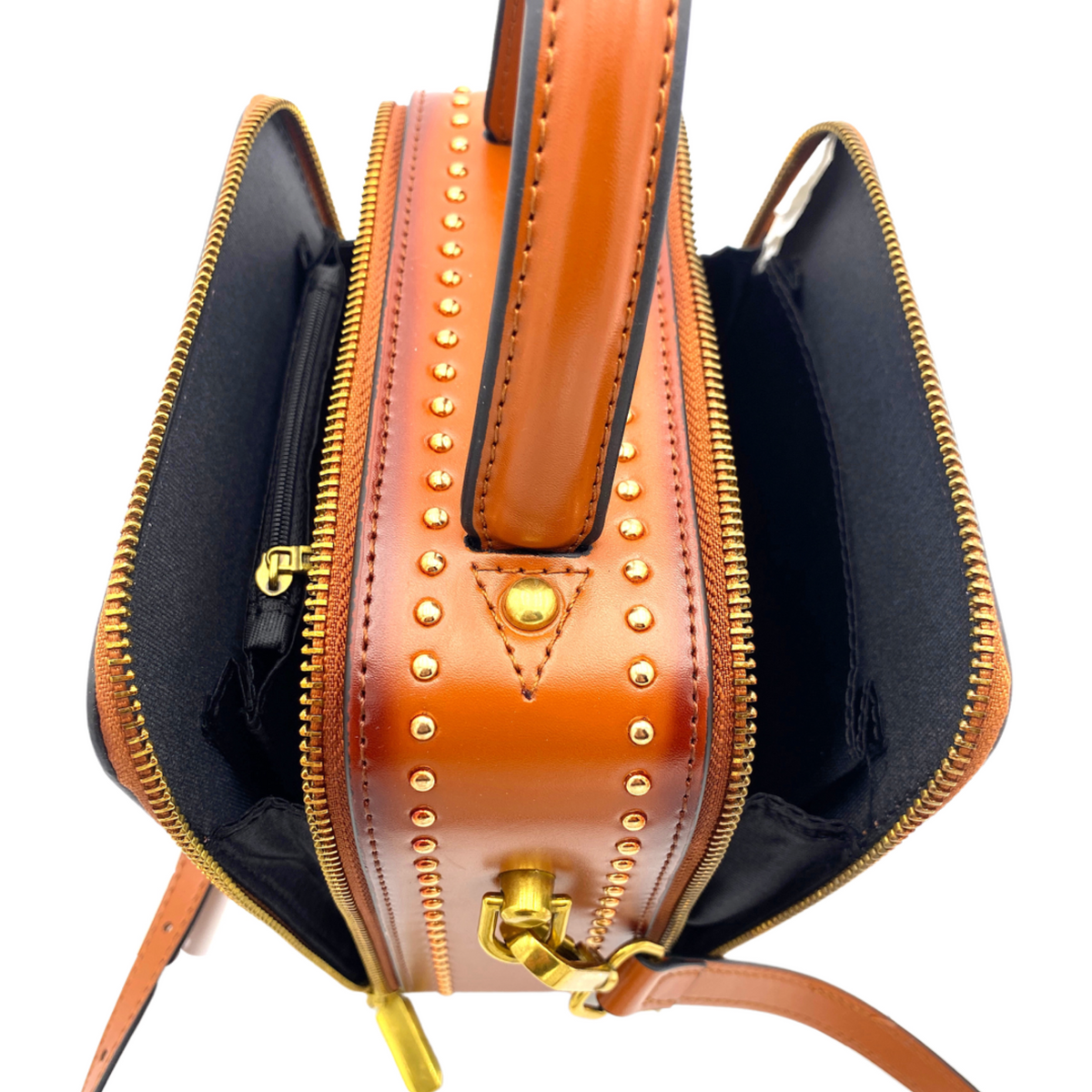 Saddle mini handbag opening with dual zippers, gold studs, and leather handle