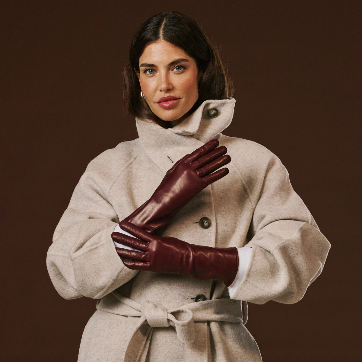 Long burgundy leather winter gloves with plush cashmere-lined cuffs and finger coverage.