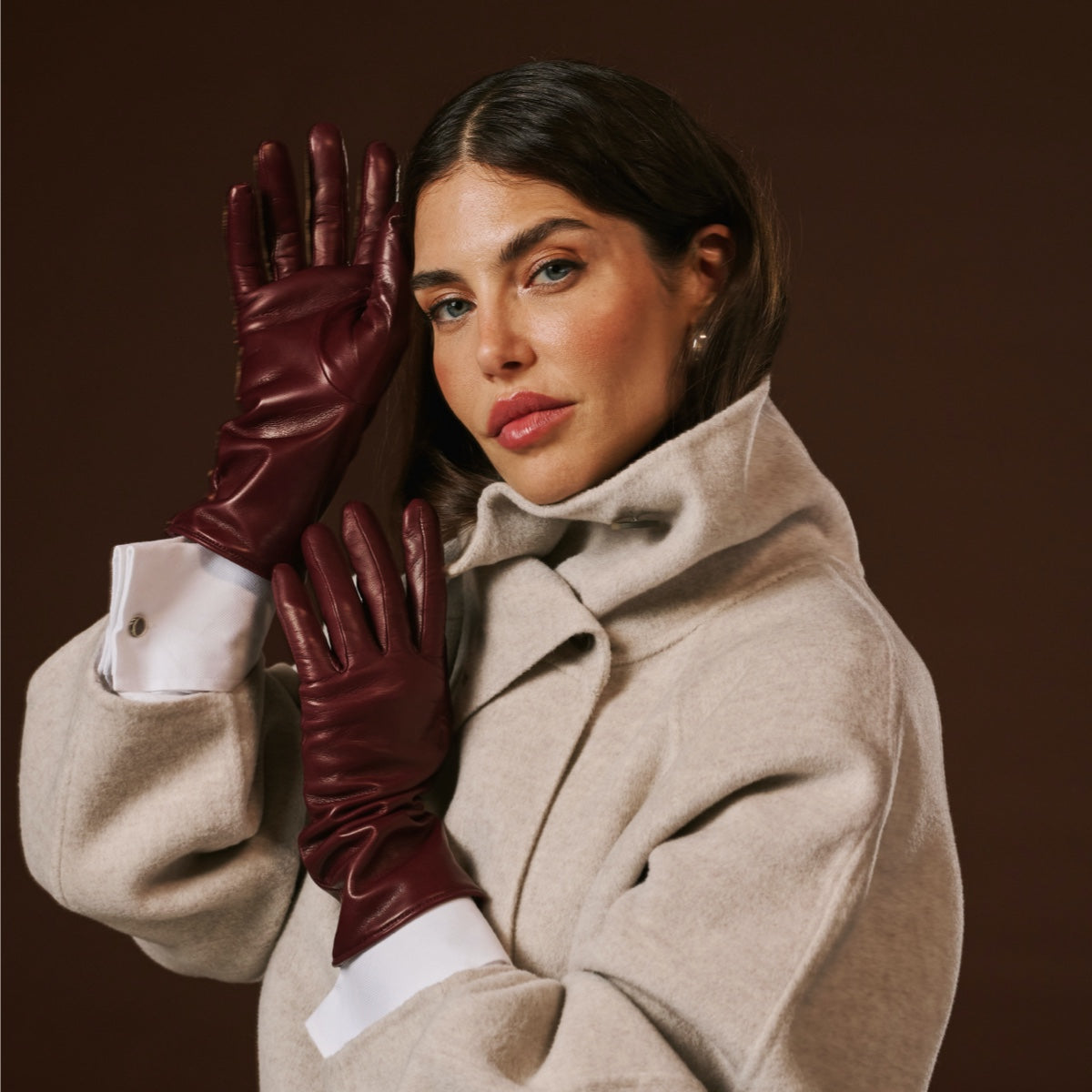 Long burgundy leather gloves with cashmere-lined cuff and fitted finger panels.