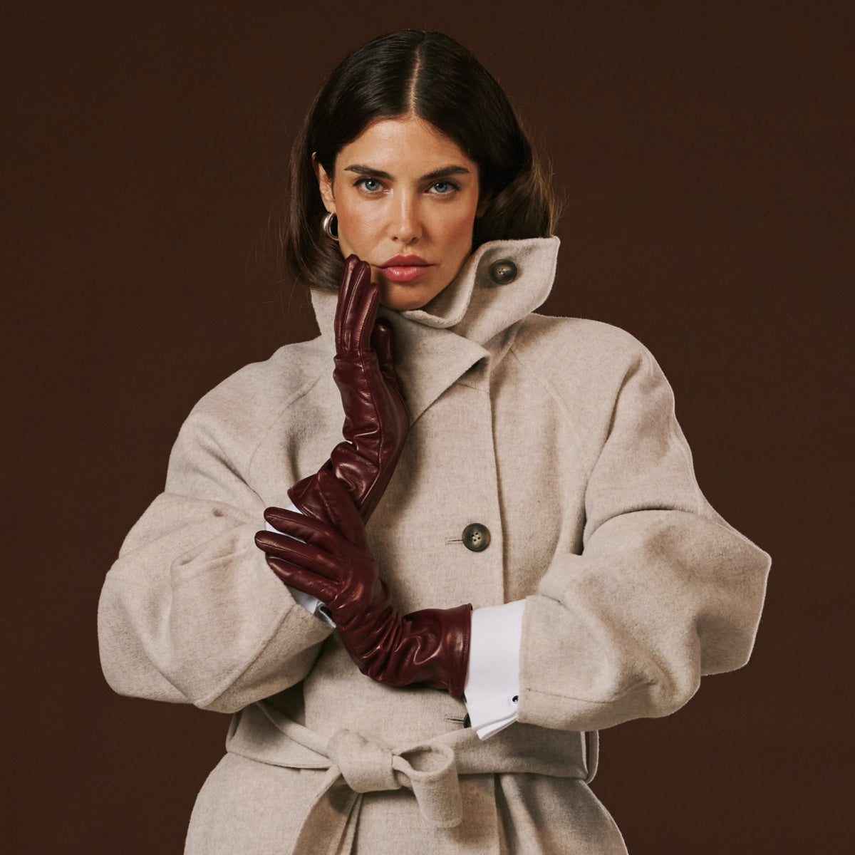 Long burgundy leather winter gloves with plush cashmere cuffs and full finger coverage.