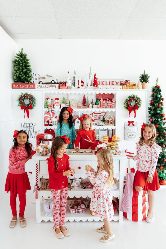 White long-sleeve ruffle tee with candy-cane and bow print, red and pink
