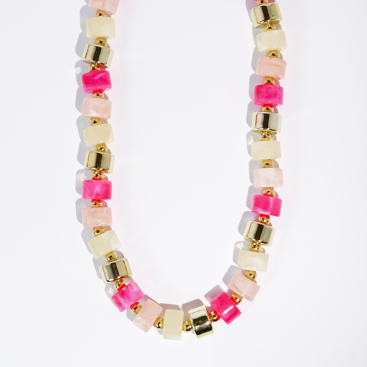 Beaded necklace with pink, white, and clear cube beads and gold-tone square accents
