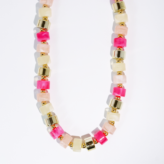 Beaded necklace with pink, white, and clear cube beads and gold-tone square accents