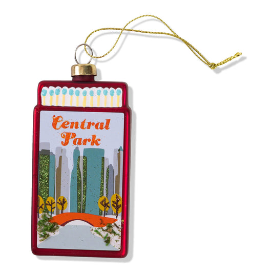 Matchbook-style ornament with red frame and Central Park graphic, gold loop and cord